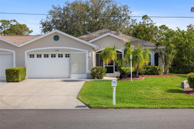 ranch-style home featuring a shingled roof, a front lawn, stucco siding, driveway, and an attached garage