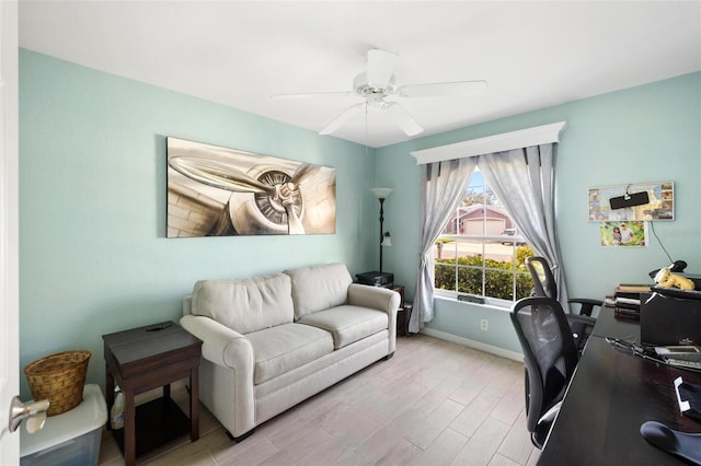 home office with baseboards, wood finished floors, and ceiling fan