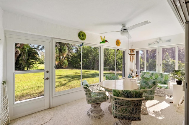 sunroom featuring ceiling fan