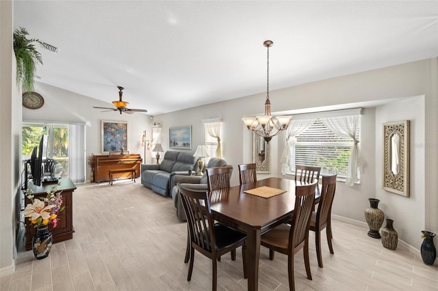 dining room with a wealth of natural light, baseboards, and light wood-style floors