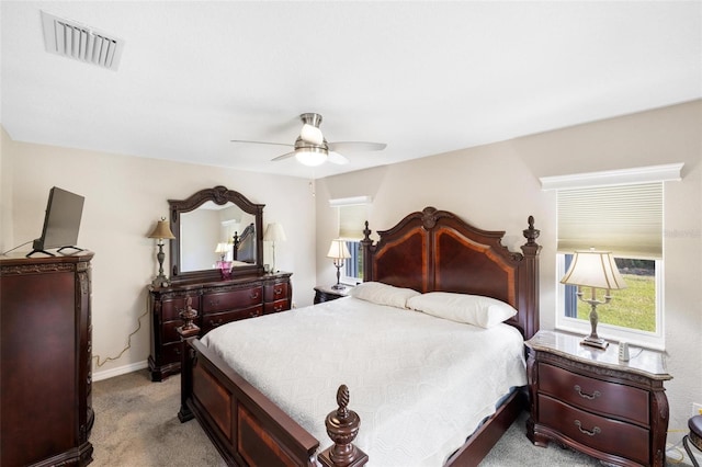 bedroom with ceiling fan, baseboards, visible vents, and light carpet