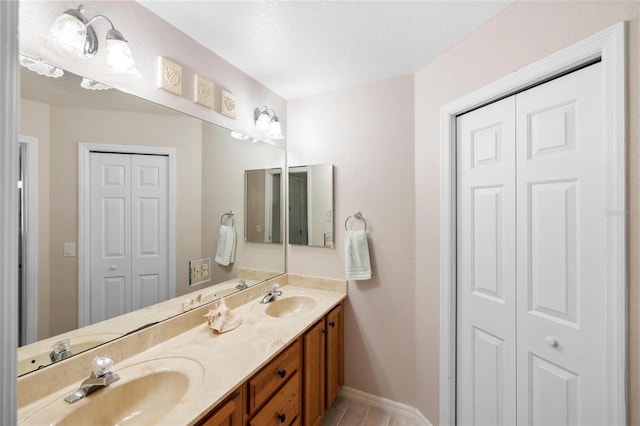 full bath featuring a sink, a closet, and double vanity