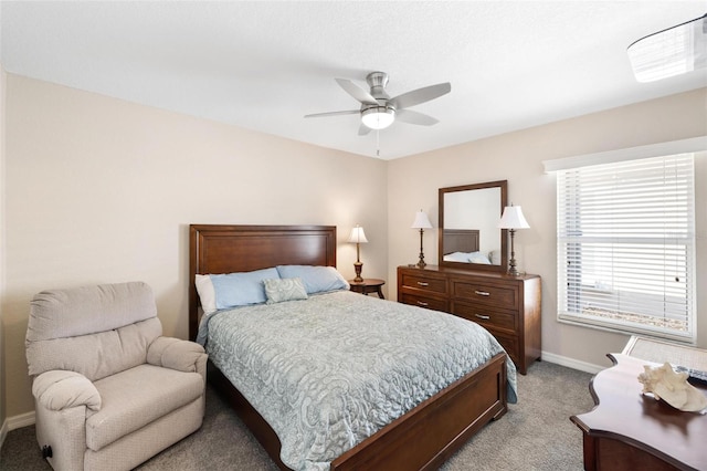 bedroom with baseboards, light carpet, and ceiling fan