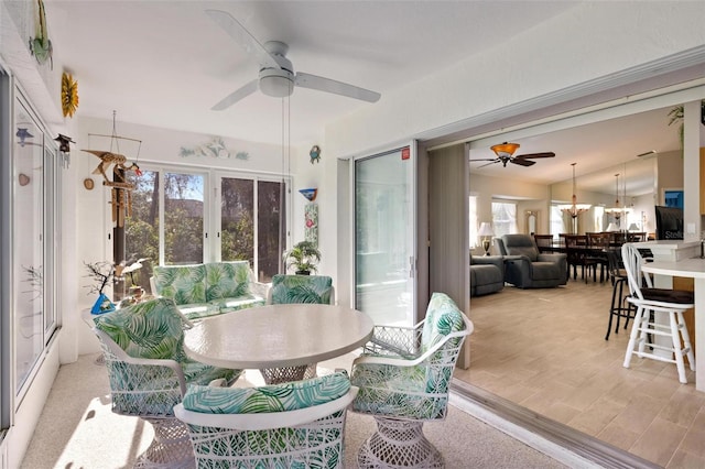 dining room featuring vaulted ceiling, a ceiling fan, and light wood finished floors