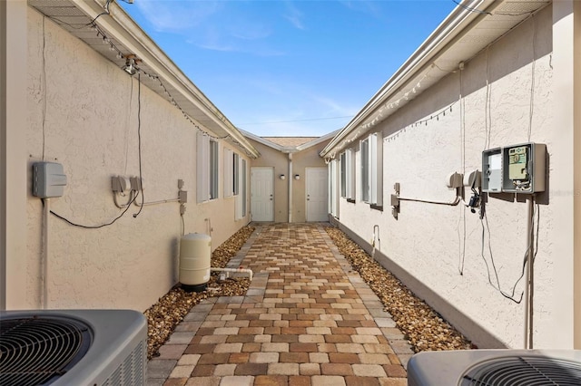 view of property exterior with cooling unit and stucco siding