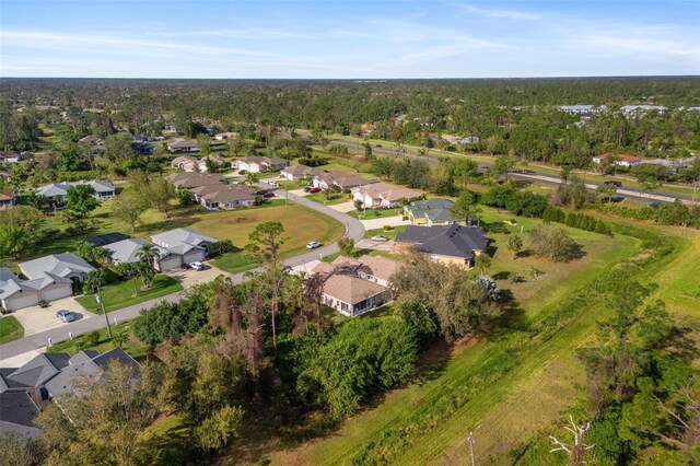 birds eye view of property featuring a residential view and a view of trees