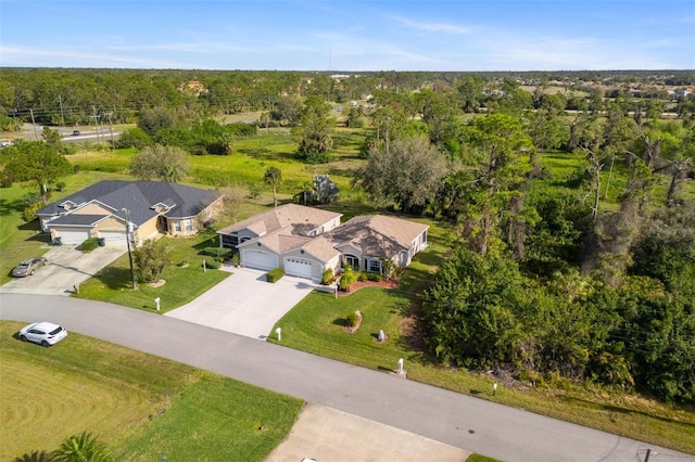 drone / aerial view with a wooded view