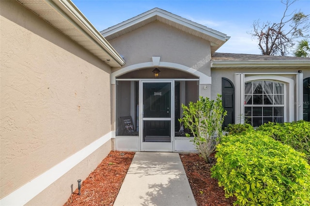 property entrance featuring stucco siding