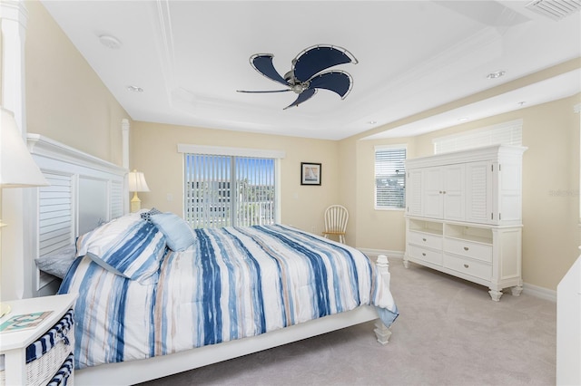 bedroom with access to exterior, a tray ceiling, visible vents, light carpet, and baseboards