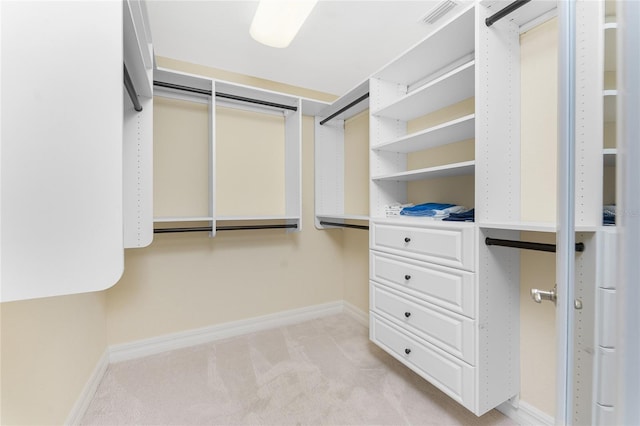 walk in closet with light carpet and visible vents