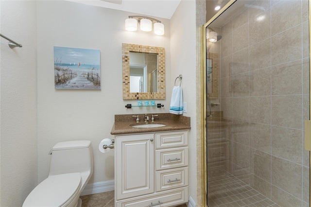 bathroom with a stall shower, vanity, and toilet