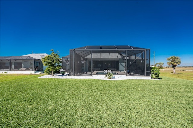 back of property featuring a lanai, a patio, and a yard