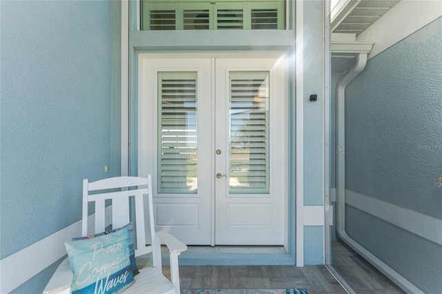 entrance to property with french doors and stucco siding