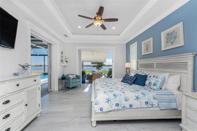 bedroom with access to exterior, a raised ceiling, multiple windows, and crown molding