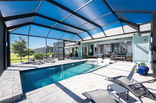 outdoor pool with a patio area and glass enclosure