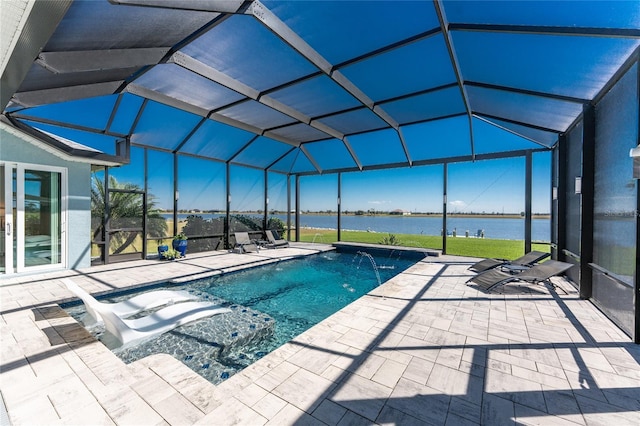 outdoor pool featuring glass enclosure, a patio area, and a water view