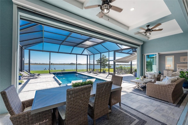 view of swimming pool with a water view and a ceiling fan