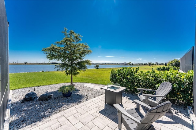 view of patio featuring a water view and a fire pit