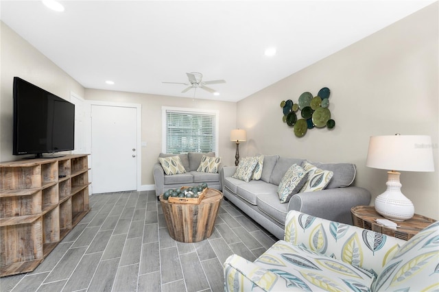 living area featuring baseboards, wood finish floors, a ceiling fan, and recessed lighting