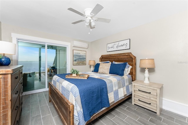 bedroom with access to exterior, wood finish floors, an AC wall unit, and ceiling fan