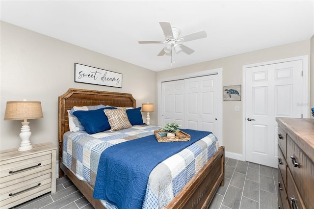 bedroom with a ceiling fan, a closet, and baseboards