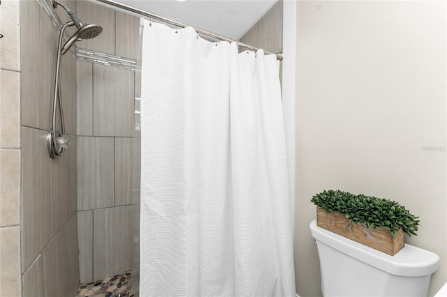 full bath featuring toilet and curtained shower