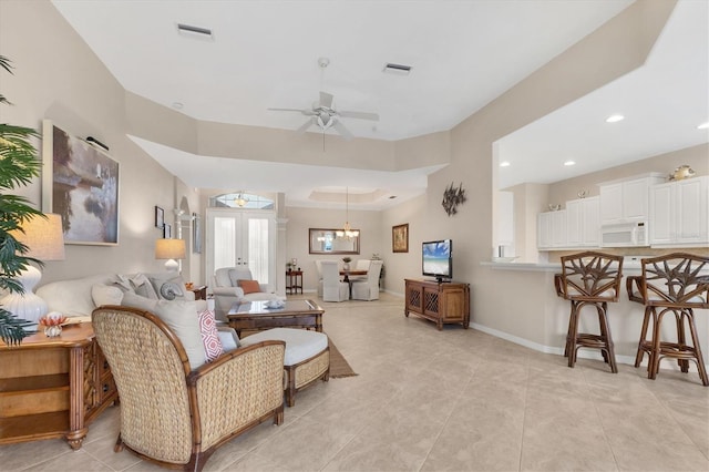 living area featuring french doors, a ceiling fan, visible vents, and baseboards