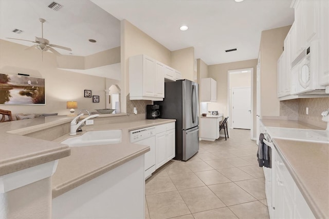 kitchen with light countertops, white appliances, a sink, and visible vents