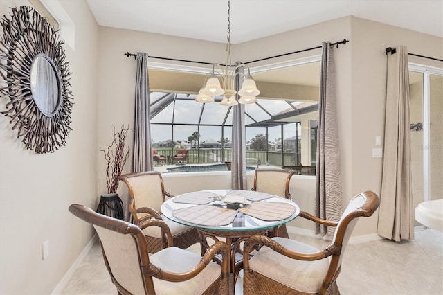 dining room featuring a sunroom, baseboards, and light tile patterned floors