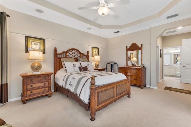 bedroom featuring light carpet, arched walkways, a raised ceiling, and visible vents