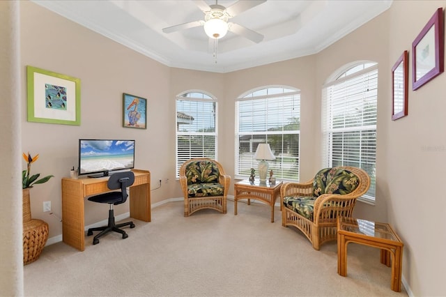 office area featuring light carpet, baseboards, a raised ceiling, and crown molding