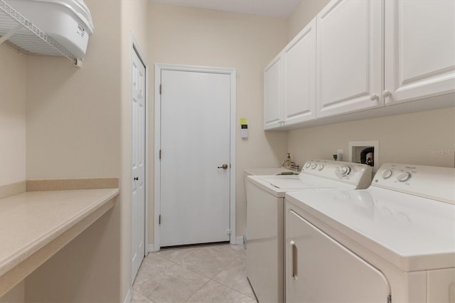 laundry room featuring cabinet space, washing machine and clothes dryer, and light tile patterned floors