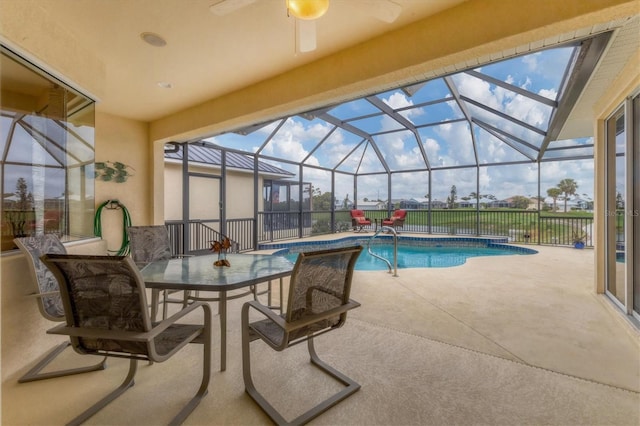 pool featuring glass enclosure and a patio area