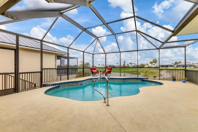 pool featuring glass enclosure and a patio