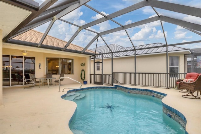 outdoor pool featuring a lanai, a patio area, and ceiling fan