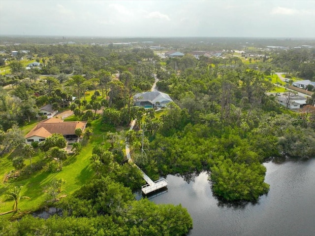 drone / aerial view featuring a water view and a forest view