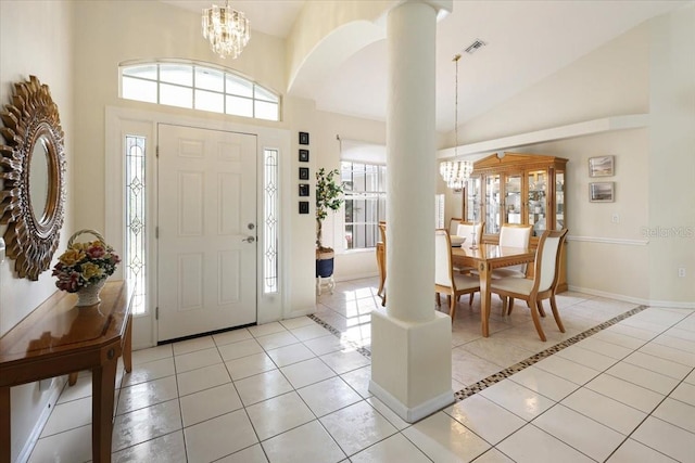 foyer with a chandelier, plenty of natural light, and light tile patterned floors