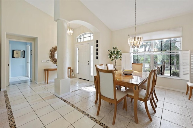 dining room featuring light tile patterned floors, baseboards, and a notable chandelier