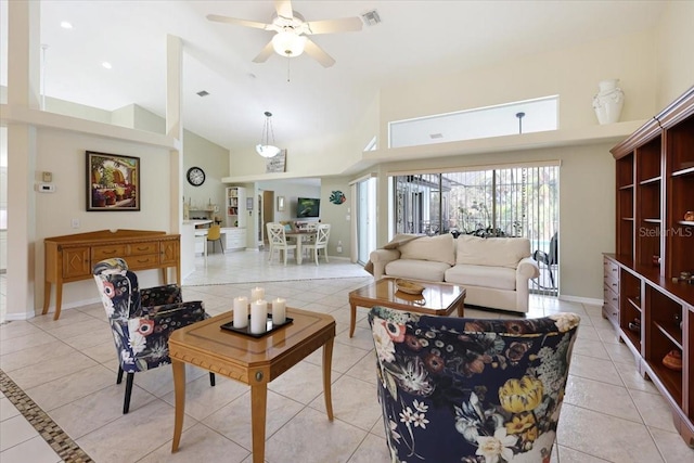 living room with light tile patterned floors, baseboards, visible vents, ceiling fan, and high vaulted ceiling