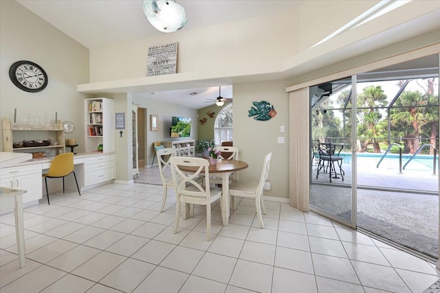 dining room featuring light tile patterned floors, ceiling fan, built in study area, and baseboards