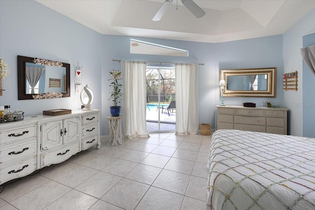 bedroom with light tile patterned flooring, a raised ceiling, a ceiling fan, and access to exterior