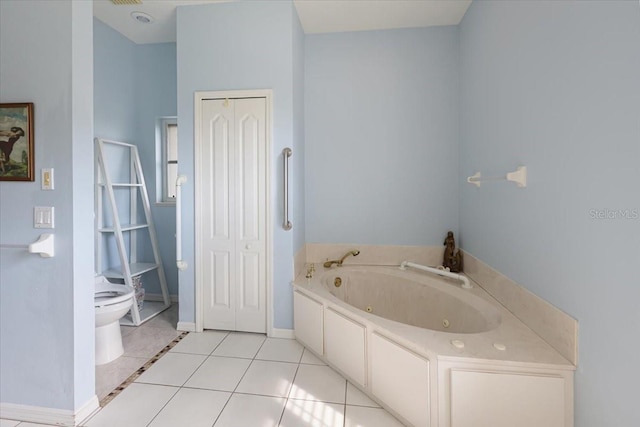 full bath with baseboards, toilet, a tub with jets, tile patterned floors, and a closet