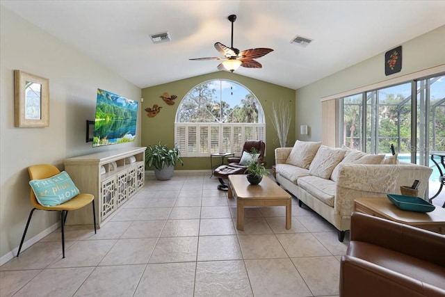 living area with vaulted ceiling, light tile patterned flooring, visible vents, and a healthy amount of sunlight