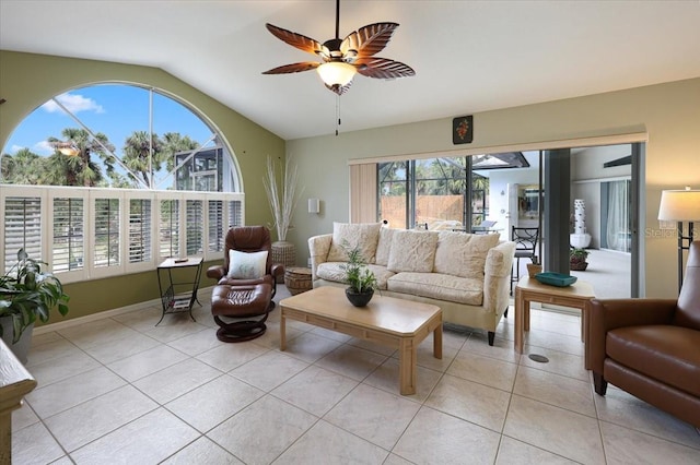 living area with lofted ceiling, light tile patterned floors, and a ceiling fan