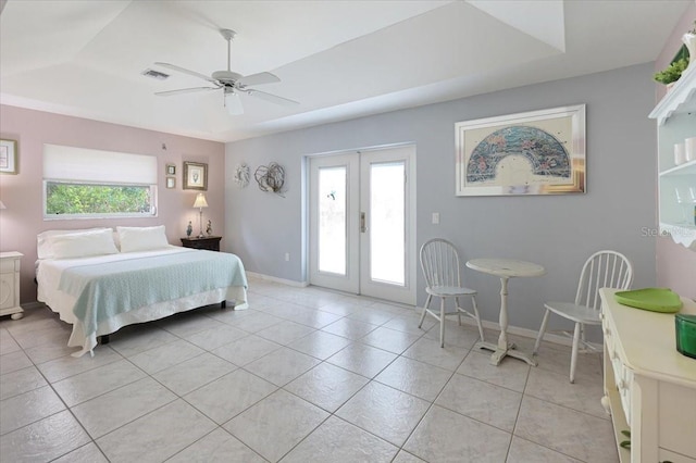 bedroom with access to outside, visible vents, a raised ceiling, and french doors