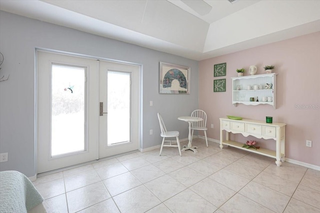 doorway to outside with light tile patterned floors, baseboards, vaulted ceiling, and french doors