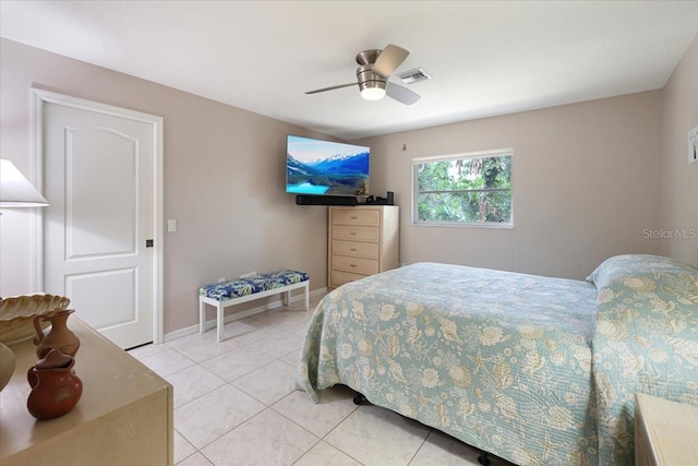 bedroom with light tile patterned floors, ceiling fan, visible vents, and baseboards