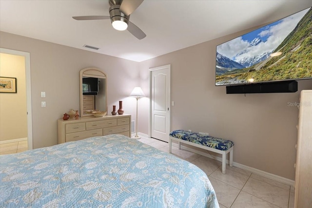 bedroom featuring visible vents, ceiling fan, baseboards, and light tile patterned floors