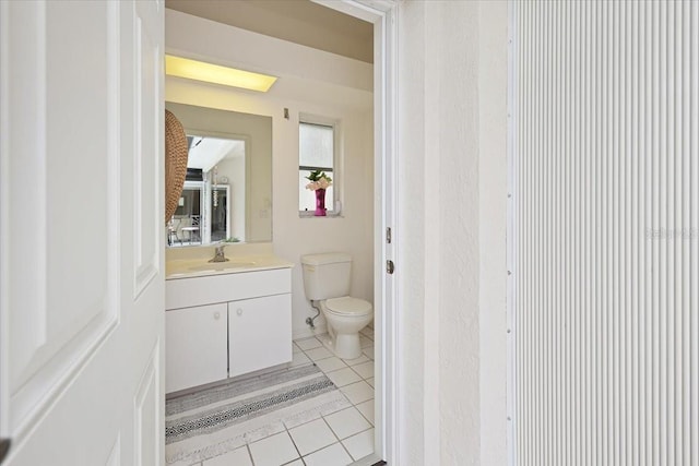 bathroom with vanity, tile patterned flooring, and toilet