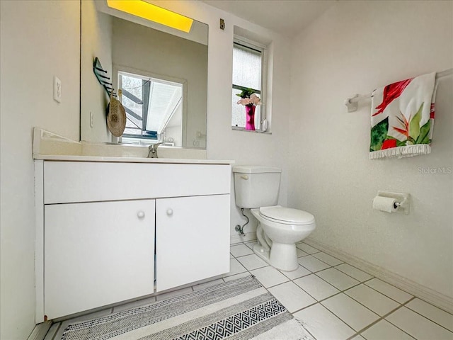 half bath featuring vanity, toilet, and tile patterned floors